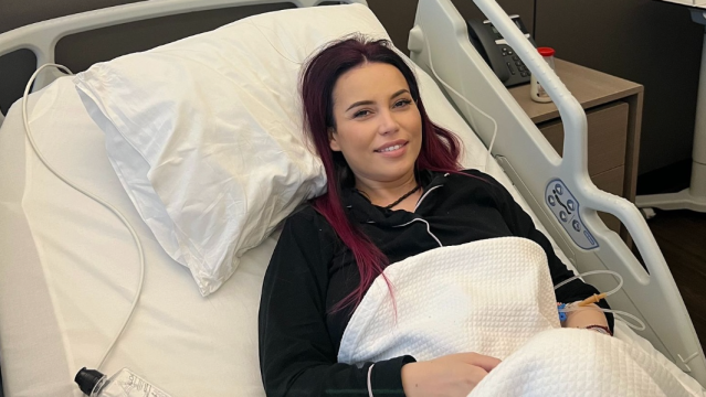 Anca Molnar smiling while laying in a hospital bed