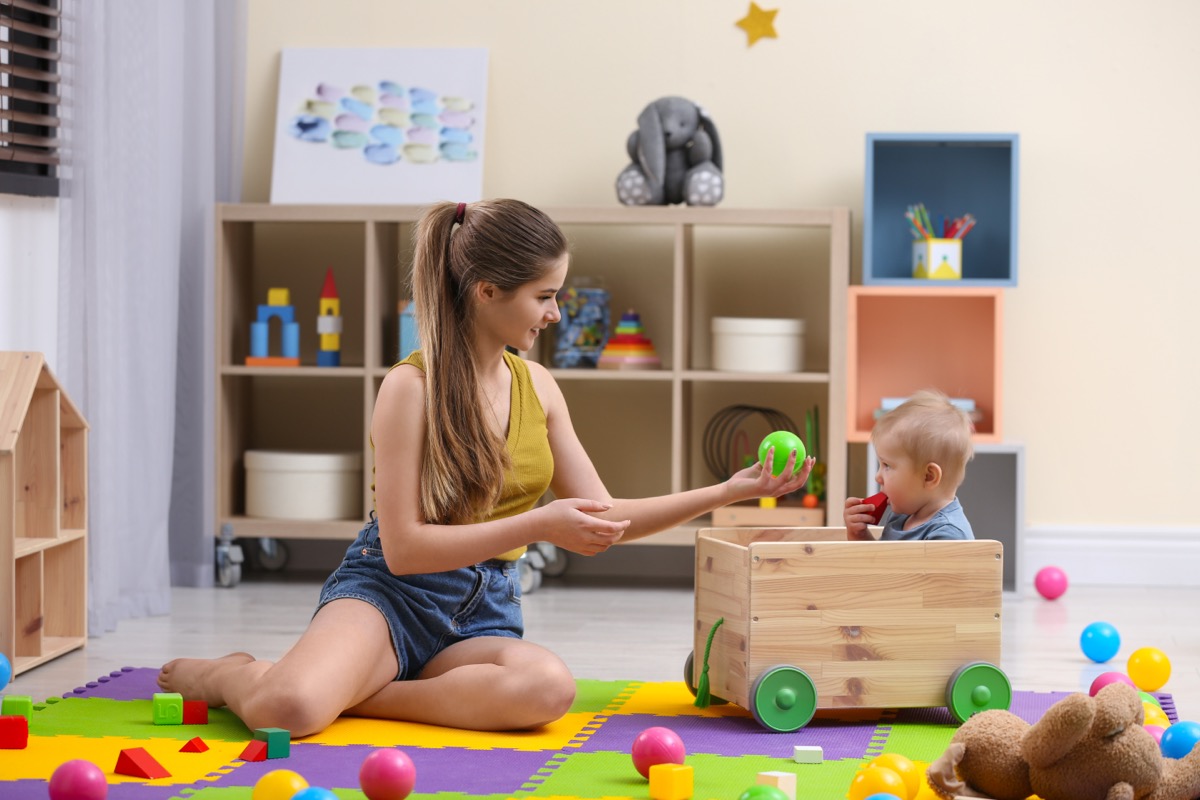 Au pair or nanny playing with toddler