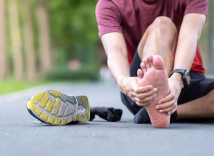Young adult male with his muscle pain during running