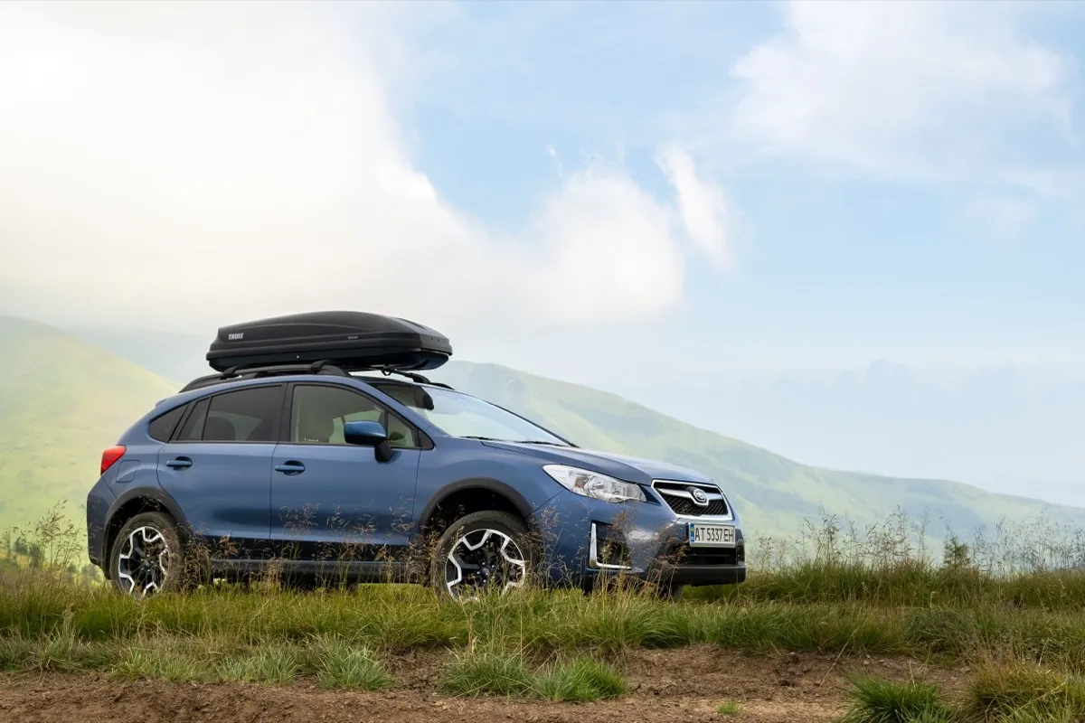 Blue Subaru Crosstrek off road car on mountain trail. Traveling by auto, adventure in wildlife, expedition or extreme travel on SUV automobile