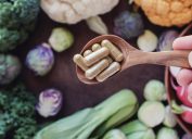 Supplements surrounded by gut healthy vegetables