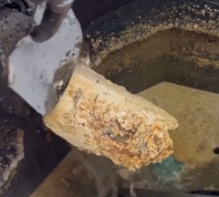 Still from a video showing a drain clogged with grease