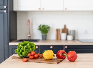 Contemporary kitchen interior design. Healthy food products on table. Salad ingredients. Cooking at home. Home comfort. Healthy nutrition and lifestyle