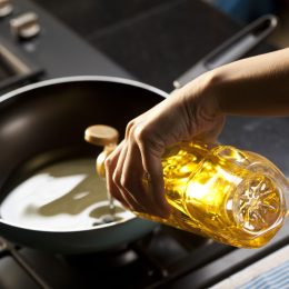 Pouring vegetable oil into frying pan
