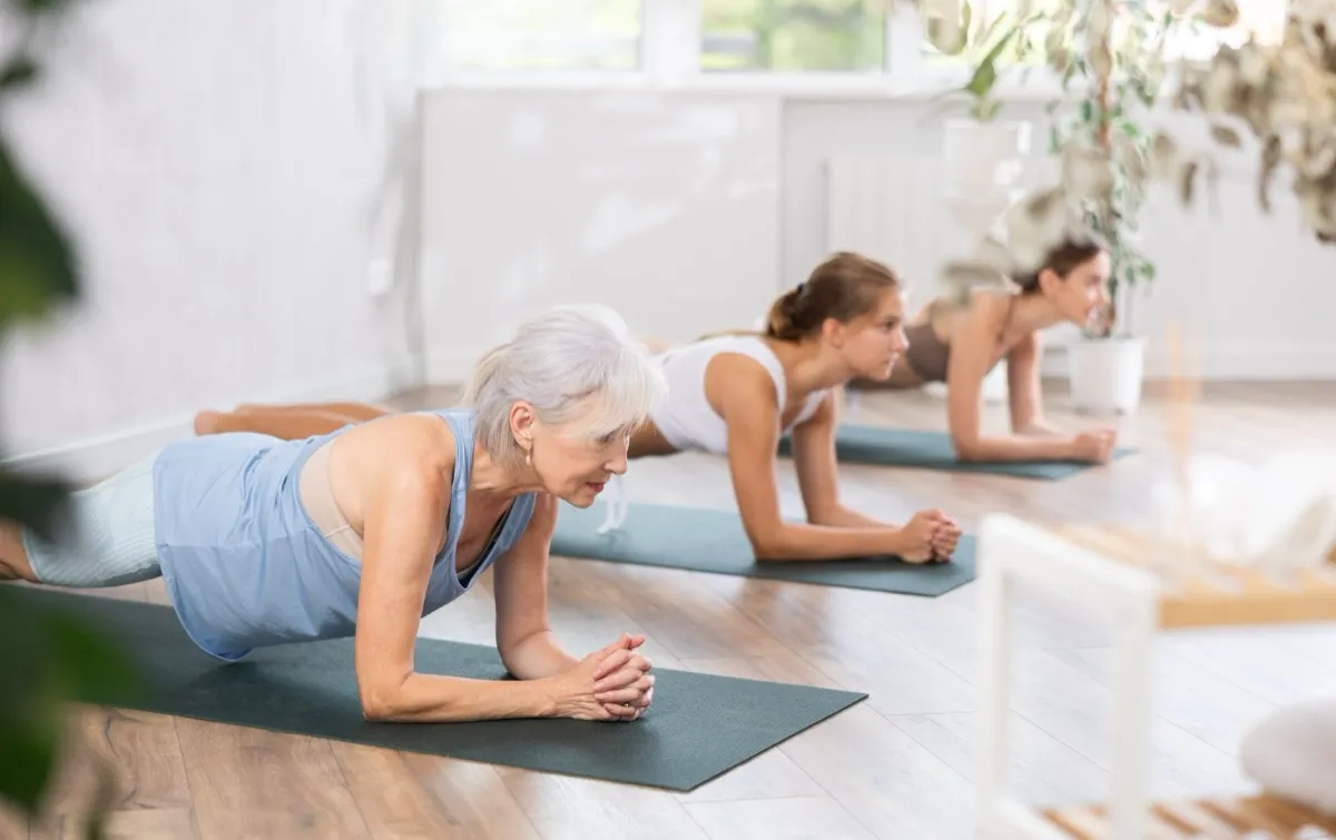 group of women doing a plank position in fitness studio