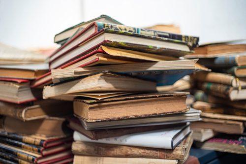 Book background. Pile of old books at a garage sale.