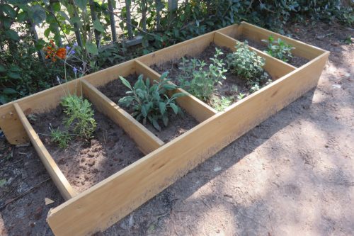 book shelf on its side repurposed as a raised garden bed