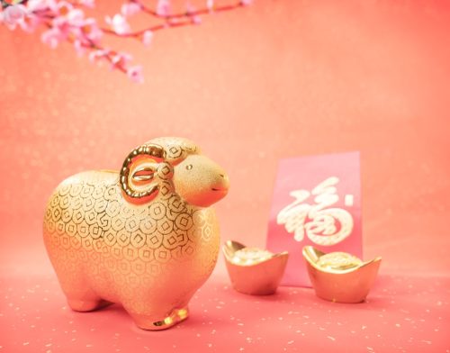 gold goat against a pink background representing the chinese zodiac