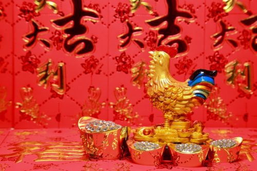 gold rooster against a red background representing the chinese zodiac