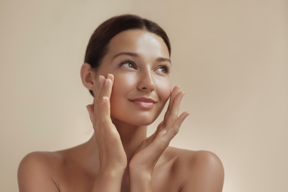 Skincare Beauty Photo of Woman with Clean Healthy Skin Touching Her Face