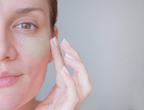 girl using tinted moisturizer on face