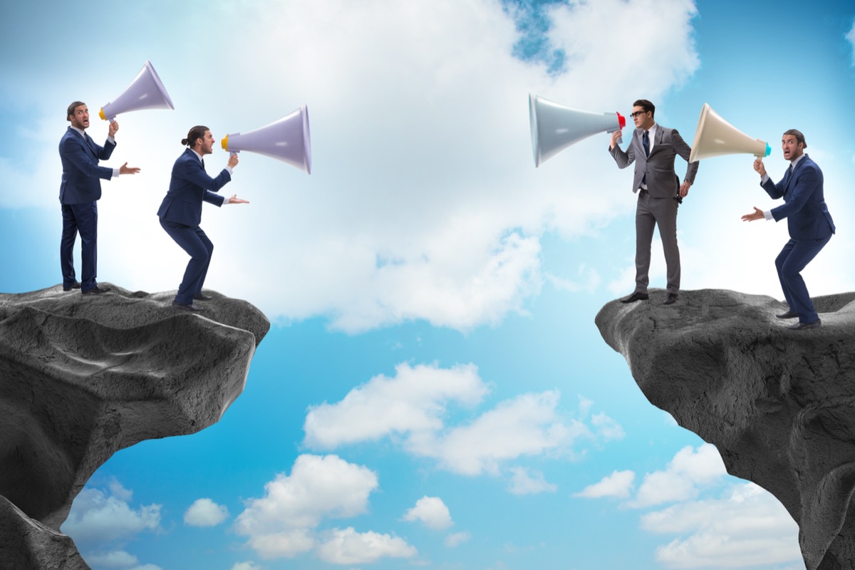 Businessman shouting with loudspeaker at each other