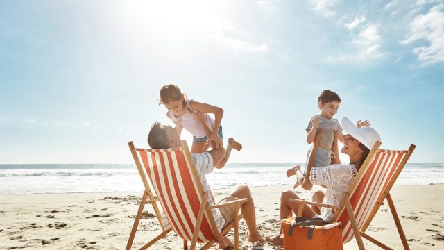A family on the beach with two children
