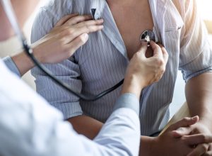 Doctor using a stethoscope checking patient with examining, presenting results symptom and recommend treatment method, Healthcare and medical concept.