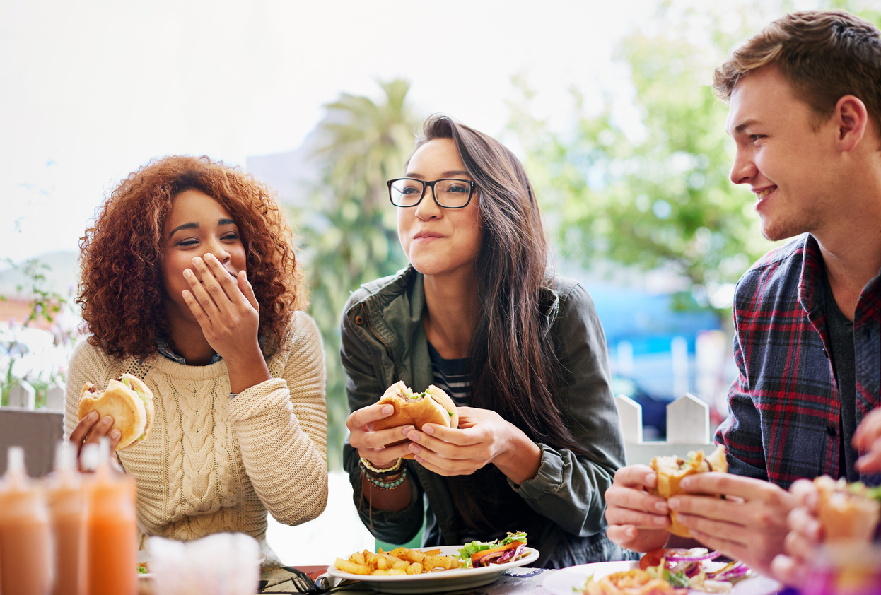 A group of friends eating lunch and laughing