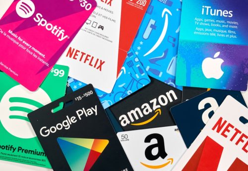 Different gift cards of many brands such as Amazon, Netflix, Xbox, Google Play, Best Buy, Spotify. A gift card is a prepaid card that you use to pay for purchases