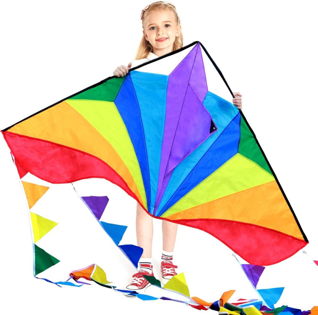 A child holding a large kite