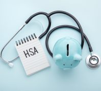 HSA note with a piggy bank and doctor's stethoscope