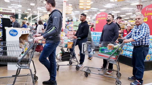 People standing in line at the Kroger grocery store.