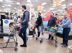 People standing in line at the Kroger grocery store.
