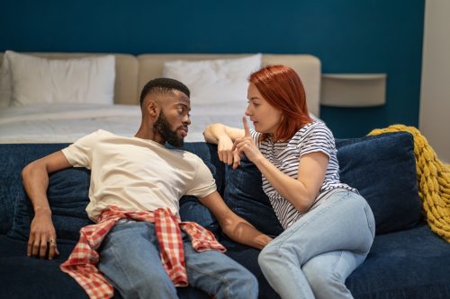 man and woman discussing problems in relationships. Husband attentively listening wife explaining difficulties gesturing hands. Misunderstanding, attempt to resolve conflict.