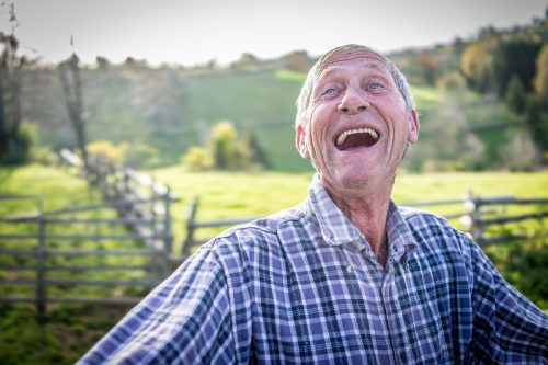 older man laughing outside