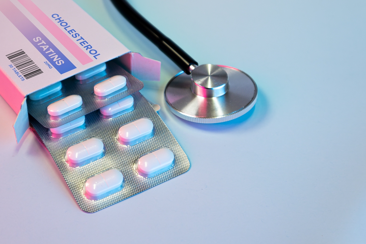 box of statin pills to control cholesterol levels next to a stethoscope