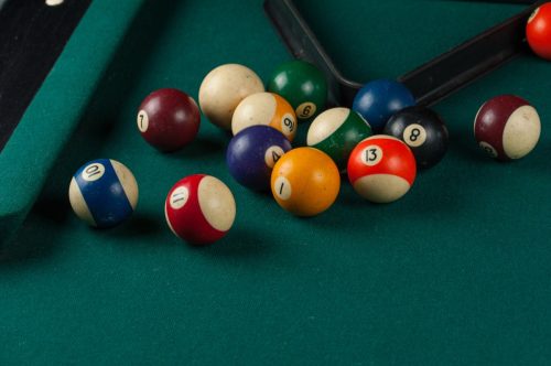 Billiards balls and cue on billiards table. Billiard sport concept