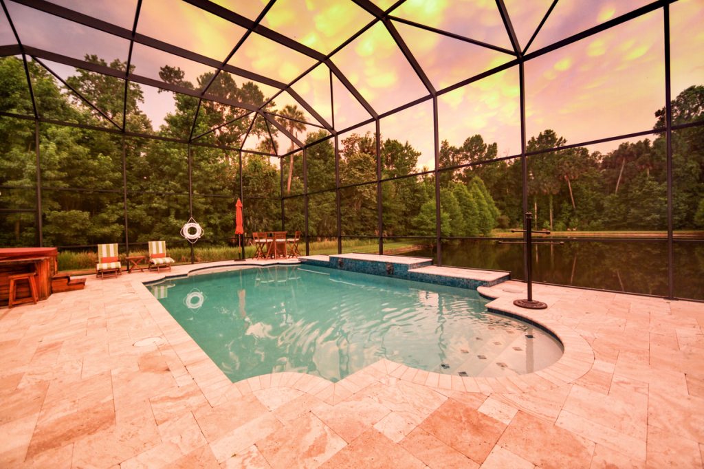 A screened-in pool patio