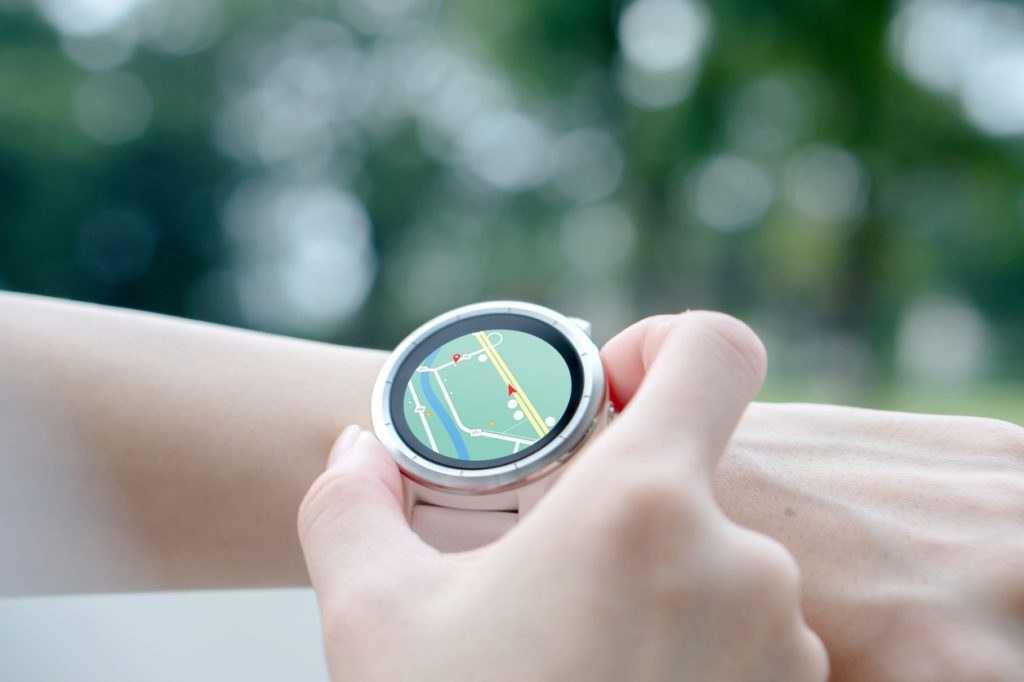 A person setting GPS on their smartwatch
