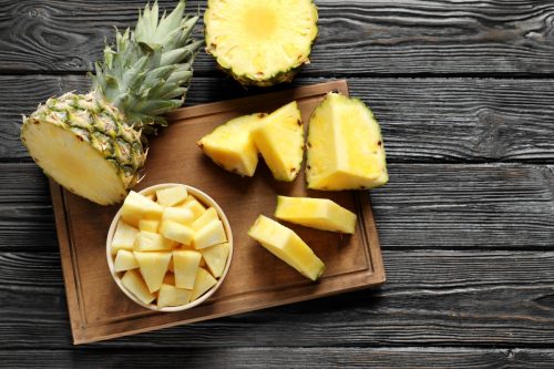 wooden board with sliced pineapple