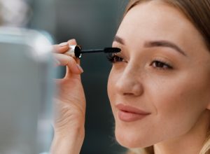 woman applying mascara