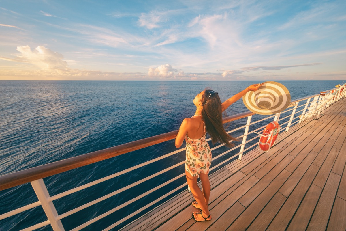 happy single woman on the deck of a cruise ship