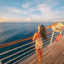 happy single woman on the deck of a cruise ship