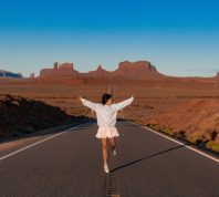 young woman posed in front of monument valley