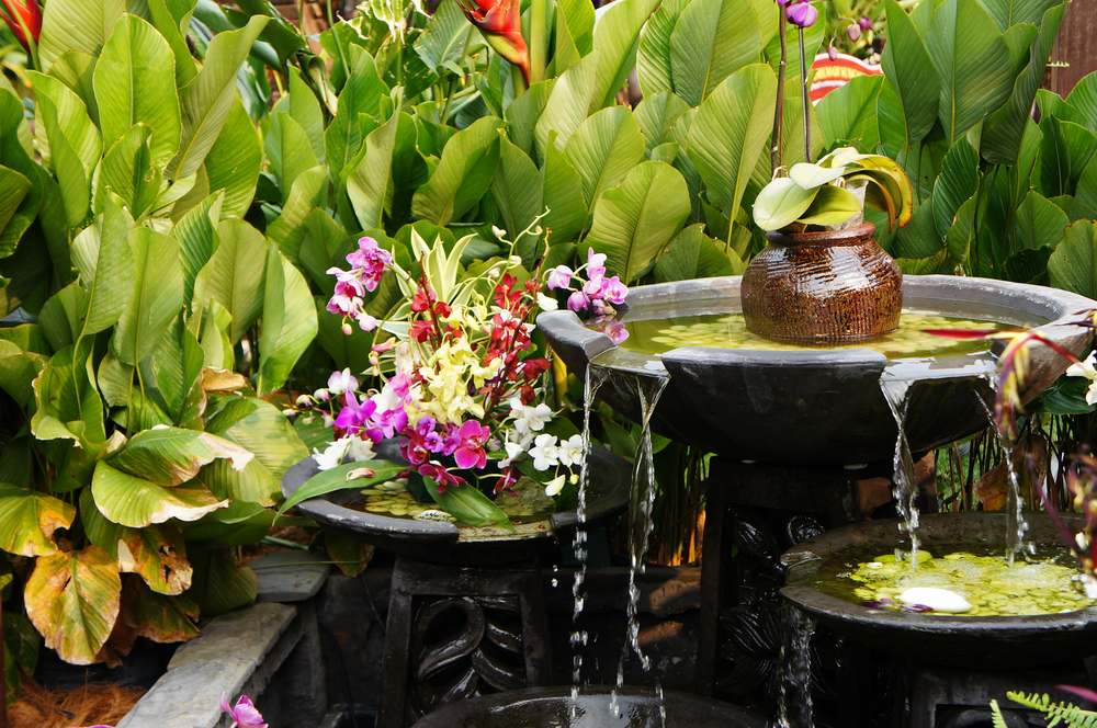 A three-tiered fountain in a garden