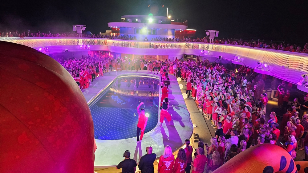 A party on the top deck of a Virgin Voyages cruise ship