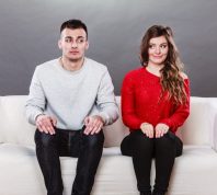 man and woman in a situationship sit awkward on a couch
