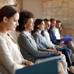 A group of people waiting in an office for a job interview