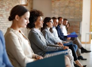 A group of people waiting in an office for a job interview