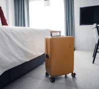 yellow suitcase in a modern hotel room