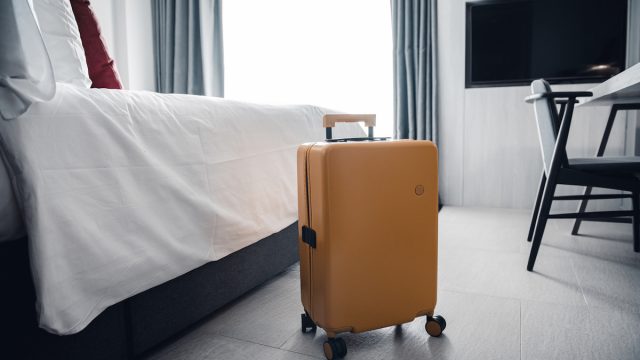 yellow suitcase in a modern hotel room
