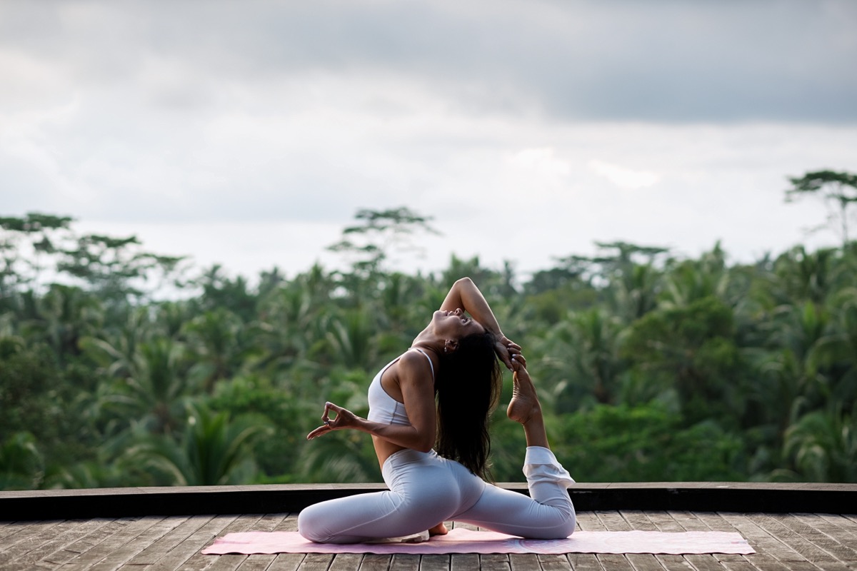Fit young woman doing yoga outside