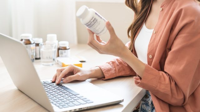 Woman looking at supplement label and doing research