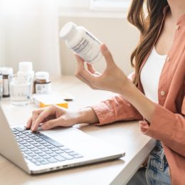 Woman looking at supplement label and doing research