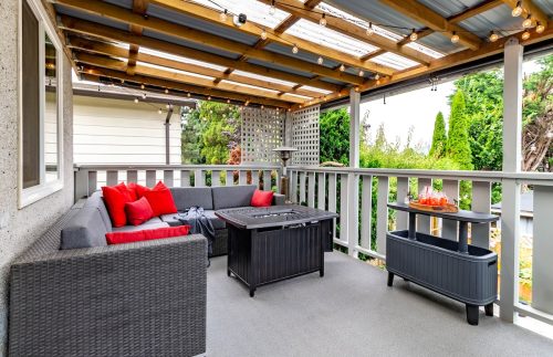 backyard deck with a pergola and gray outdoor furniture
