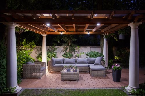 Backyard pergola with an outside seating area at night