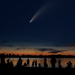 Comet Neowise and crowd of people silhouetted by the Ottawa river watching and photographing the comet