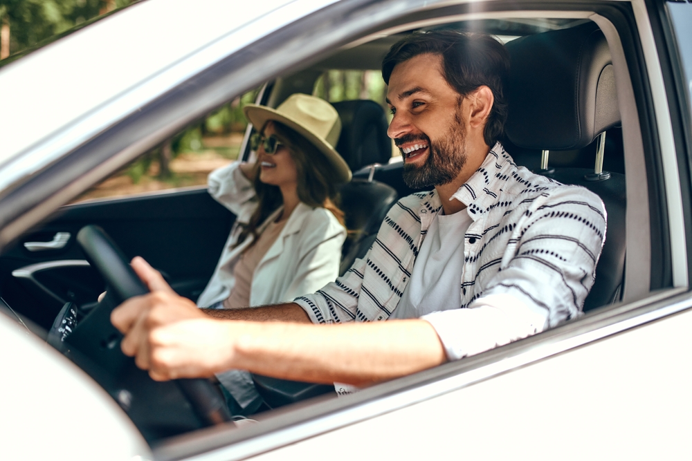 A couple in a car smiling