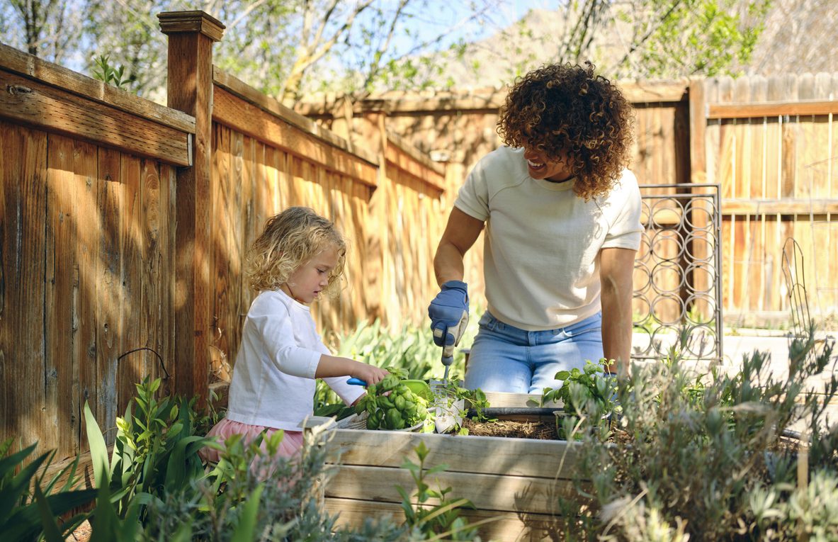A woman and young girl gardening